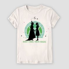 Your darling will be ready to enter a magical world wearing the Wicked Short-Sleeve T-Shirt. This ivory T-shirt showcases a scenic illustration from the movie "Wicked" featuring Elphaba and Glinda along with the message "Don't Hide Your Magic" for a whimsical touch. Made with cotton in a tagless design, this lightweight T-shirt is comfortable to wear. Plus, the crewneck T-shirt comes in a pullover style for quick dressing and changing. Scenic Illustration, Wicked Shirt, Elphaba And Glinda, Mickey Mouse Shorts, Magical World, Fabric Tape, Kids Outfits Girls, Disney Girls, Fabric Names