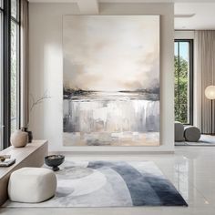 a large painting hanging on the wall in a living room