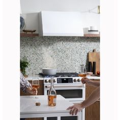 two people are toasting with wine in the kitchen