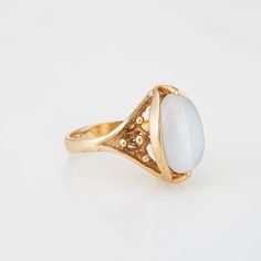 Stylish vintage moonstone cocktail ring (circa 1960s to 1970s) crafted in 10 karat yellow gold.    Cabochon moonstone measures 13.5mm x 9mm. The moonstone is in very good condition and free of cracks or chips.    The luminous moonstone glows with every movement of the hand, securely set in a bezel style mounting. The cocktail ring makes a nice statement on the hand. The medium rise ring (9mm - 0.35 inches) sits comfortably on the finger.    The ring is in very good condition and was lightly cleaned and polished.    Particulars:    Weight: 6.2 grams    Stones: Cabochon moonstone measures 13.5mm x 9mm. The moonstone is in very good condition and free of cracks or chips.    Size & Measurements: The ring is a size 5 3/4 (sizable). The mount measures 17mm in length (0.66 inches) and 11mm wide ( Hallmarked Yellow Gold Moonstone Ring, Heirloom Oval Moonstone Ring, Antique Oval Cabochon Moonstone Ring For Formal Occasions, Classic Yellow Gold Oval Cabochon Moonstone Ring, Antique Moonstone Ring, Oval Cabochon, Gold Cabochon Moonstone Ring Collectible, Formal 14k Gold Oval Cabochon Moonstone Ring, Antique Oval Cabochon Moonstone Ring, Antique Oval Moonstone Ring