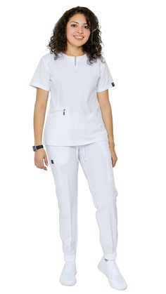 Be ready to impress the second you put on Dress A Med's Soft Stretch Silver Zipper jogger set. This 2 piece uniform scrubs set is ultra-flattering with its accent silver zipper neckline. You'll be sure to show off your figure while still maintaining your trusted and professional image. This uniform soft stretch scrubs set is made to be dazzling as you are with its accentuating double stitch lines. The scrub top is modern yet ultra-useful with a zipper compartment and 2 large pockets. The jogger White Nursing Uniform Design, White Scrubs Outfit, Nurses Scrubs Uniform, Stylish Scrubs Nurses, Scrub Uniform Ideas, Nurses Dress Uniform Style, Nurse Uniform Modern White, Scrubs Uniform Cute Medical, Stylish Scrubs For Women