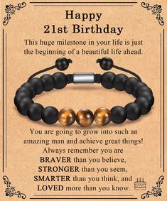 a happy 21st birthday card with two black and gold bracelets on an old paper background