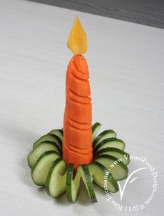 a candle made out of cucumbers and sliced carrots