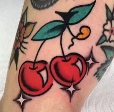 a close up of a person's leg with an apple tattoo design on it