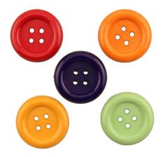 four different colored buttons on a white background