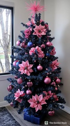 a christmas tree decorated with pink and blue ornaments