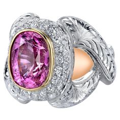 An impressive 7.08 carat bubblegum pink sapphire sits center stage in this majestic statement ring. The pink sapphire is a bright, rich pink color with exceptional clarity and brilliance! It is accompanied by Gemological Institute of America report certifying the authenticity of this important gem. Pink sapphires that are of this quality and such a large size are increasingly rare, making this an even more important piece of jewelry. We have set this beauty in a rich, 18k yellow gold bezel that Gold Cocktail, Diamond Cocktail Rings, Gold Work, Modern Ring, Bubblegum Pink, Modern Jewelry, Pink Sapphire, Cocktail Rings, Statement Ring