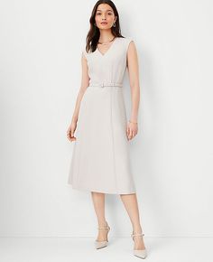 Elevate your wardrobe with the Ann Taylor Belted V-Neck Midi Dress, a piece that blends sophistication with comfort. This dress is perfect for any season and is sure to turn heads with its elegant V-neckline and flattering midi length.

- **Size**: Regular - 2
- **Color**: Ivory Whisper
- **Material**: 95% Polyester, 5% Spandex
- **Fit**: Tailored
- **Length**: Hits below the knee, approximately 30" from natural waist
- **Sleeves**: Cap sleeves
- **Closure**: Hidden back zipper with hook-and-eye Knitted Suit, V Neck Midi Dress, Dresses Dresses, Feminine Dress, Ann Taylor Dresses, Petite Outfits, Buckle Belt, Crepe Fabric, Elegant Dress