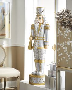 a large nutcracker statue sitting on top of a white table next to a window