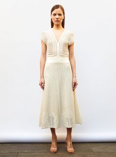 This long, lightweight, long luxury knit dress is knit in Italy from high-quality mercerized cotton. The knitwork results in a graphic, openwork wicker knit with a perfect drape. Subtly nipped in at the waist, this model has a ravishing fullness and features a deep V-neckline in both front and back with armholes that delicately cover the shoulder. In a "natural" color, wear this knitted dress in summer with sandals and colorful jewelry, and in winter under a black jacket with a pair of tights and leather boots for a sophisticated look. The model is 1m78 tall and wears a size S. Chic Crochet Open Knit V-neck Dress, Elegant Open Knit Summer Dresses, Elegant Open Knit Crochet Dress For Summer, Elegant Crochet Knit Maxi Dress, Elegant Open Knit Spring Dress, Elegant Spring Open Knit Dress, Elegant Open Knit Crochet Dress For Spring, Elegant Beige Open Knit Dress, Elegant Midi-length Crochet Dress With Pointelle Knit