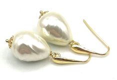 A pair of elegant earrings crafted with 24 K Gold Vermeil Made in Italy and simulated baroque white pearls. Would make a great gift for June birthdays or for bridesmaids. LENGTH:  1.7 inches - 4,4 cm  - 7 gr.  Pearl:   21 x 16 mm MATERIALS: 24 K Gold Vermeil - Made in Italy Simulated Pearls DELIVERY: All jewellery is shipped in a working day with registered mail. If you require quick delivery, please consider our Express Shipping option. Free pouch drawstring bag with every order BACK to SOFIA'S BIJOUX for more bespoke handmade jewellery. Gemstone Jewellery, bridesmaids gifts and birthstones: http://www.etsy.com/it/shop/Sofiasbijoux More Pearl Jewellery: https://www.etsy.com/uk/shop/Sofiasbijoux?section_id=28456147 More Earrings: https://www.etsy.com/uk/shop/Sofiasbijoux?ref=simple-shop-he White Pear-shaped Bridal Earrings For Party, Pear-shaped White Bridal Earrings For Party, White Pear-shaped Party Jewelry, Handmade Elegant Teardrop Earrings For Anniversary, Elegant Handmade Teardrop Earrings For Anniversary, Handmade Teardrop Bridal Earrings For Formal Occasions, Formal White Teardrop Earrings With Ear Wire, White Pearl Earrings With French Hook For Gift, White Pearl Earrings With French Hook