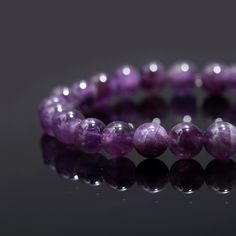 Amethyst Bead Bracelet 8 mm Round Natural Purple Amethyst Beaded Bracelet High Quality Gemstone Bead Bracelets Stone : Amethyst Shape : Round Style : Smooth Beads Size : 8 mm  Bracelet Length: 7 inch  Drill Size: 1 mm Quality : AAA+ Grade High Quality Often viewed as a stone of peace, some believe amethyst's calming presence produces soothing dreams by bringing the dreamer more in tune with the Divine. This clarity and peacefulness also extends to the waking mind. Amethysts are said to help the Hand-strung Amethyst Stretch Bracelet, Purple 8mm Bead Bracelet, Purple 8mm Beads Bracelet, Purple Gemstone Beads Stretch Bracelet, Purple Crystal Bracelet With 8mm Beads As A Gift, Amethyst Stretch Bracelet With Round Beads For Gift, Purple Round Bead Gemstones For Gifts, Amethyst Beaded Stretch Bracelet, Amethyst Beaded Stretch Bracelet With Round Beads