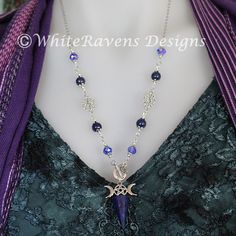 a woman wearing a necklace with a purple ribbon around her neck and an amethyst pendant on it