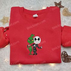 Introducing our Jack Skellington And Grinch Embroidered Shirt, a perfect blend of comedy and style. This funny embroidered t-shirt is the ultimate gift for your family, bringing smiles and laughter to any occasion. With intricate embroidery showcasing Jack Skellington and Grinch, this shirt stands out from the crowd. Made from high-quality materials, it offers exceptional comfort and durability. Whether worn casually or as a statement piece, this shirt is sure to turn heads. Unlock the joy and f Grinch And Jack Skellington, Halloween Gift Ideas, Mickey Pumpkin, Mickey Balloons, Whimsical Halloween, Shirt Making, Unique Hoodies, Halloween Hoodie, Oogie Boogie