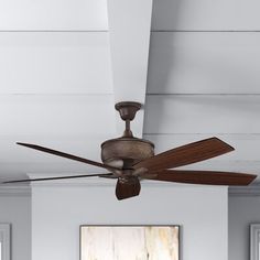 a ceiling fan in a living room with white walls