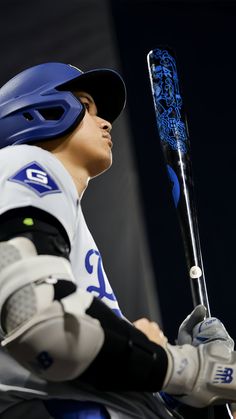 a baseball player holding a bat in his hands