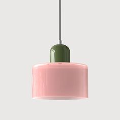 a pink and green light hanging from a ceiling