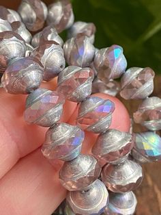 a close up of a person holding some beads