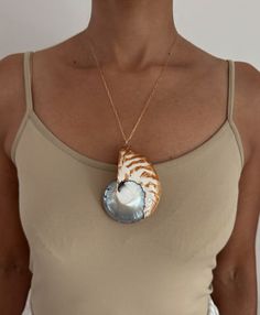 NAUTILUS SEA SHELL is a symbol of nature's grace in growth, expansion, and renewal. Known for deflecting negative energies, the Nautilus also purifies the surrounding space and attracts loving energies. The shell may be used to assist in meditation and invokes calmness, provides strength, balance and renews the physical energy. - Gold Filled Shiny Dainty Chain Gold Filled Lobster Clasp and Jump Ring 3" Nautilus Sea Shell 20" Length House of Olia is committed to utilizing only sustainable leather Nautilus Shell Necklace, Handmade Natural Shell-shaped Jewelry, Handmade Gold Shell Necklace, Spiritual Style, Artisan Shell-shaped Necklace Made Of Shell, Luxury Artisan Shell-shaped Jewelry, Sea Shell Necklace, The Nautilus, Sustainable Leather, Seashell Necklace