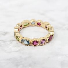 Gold Plated Colorful Stones Eternity Gemstone Ring | Harfi | Wolf & Badger Multicolor Oval Ring With Gemstone Accents, Elegant Multicolor Rings With Bezel Setting, Gold Oval Multi-stone Stackable Rings, Multi-stone Stackable Rings, Birthstone Ring With Gemstone Accents In Cubic Zirconia, Birthstone Ring With Cubic Zirconia And Gemstone Accents, Multicolor Gemstone Stackable Rings, Multicolor Oval Crystal Gemstone Ring, Multicolor Multi-stone Birthstone Ring, Oval Shaped