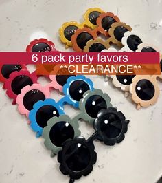 six pack party favors for clearance on a white plate with pink, blue, yellow and black sunglasses