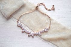 "This delicate vine inspired rose gold bracelet is the perfect, feminine finishing touch for a bride or bridesmaid! - Bracelet measures 10\" with adjustable slide clasp - Handcrafted with high quality cubic zirconia - Available in rose gold, yellow gold and rhodium (silver) finishes Browse My Entire Shop For More Jewelry & Accessories: https://www.etsy.com/shop/TheExquisiteBride Browse My Shop For Earrings: https://www.etsy.com/shop/TheExquisiteBride?section_id=14483895 Browse My Shop For Br Elegant Rose Gold Bracelets For Wedding, Elegant Rose Gold Chain Bracelet For Party, Delicate Rose Gold Bracelets For Party, Dainty Rose Gold Bracelets For Party, Elegant Wedding Diamond Bracelet With Adjustable Chain, Adjustable Rose Gold Diamond Bracelet For Wedding, Dainty Rose Gold Bracelets For Wedding, Elegant Rose Gold Chain Bracelet For Wedding, Adjustable Rose Gold Bracelets For Wedding