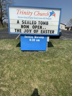 a sign in front of a church that says, trinity church a sealed tomb now open the joy of easter