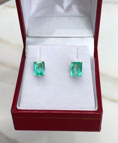 Featured here is a beautiful set of emerald cut Colombian emerald studs in fine 14K yellow gold. Displayed are medium-light green emeralds with excellent transparency, accented by a simple four-prong 14K gold mount, allowing for the emerald to be shown in full view. The earth mined, green Colombian emeralds have a desirable lush green color with excellent qualities. These earrings are ideal for everyday use and are the perfect accessory to any outfit. Total Carat Weight: 2.05cts Setting Style: F Gia Certified Square Cut Emerald Jewelry, Square Cut Emerald Jewelry For Formal Occasions, Hallmarked Rectangular Emerald Jewelry, Fine Emerald Jewelry In Rectangular Shape, White Gold Rectangular Emerald Jewelry, Rectangular Emerald Fine Jewelry, Classic Emerald Jewelry With Rectangular Stone, Rectangular Emerald Ring With Diamond Cut For Gift, Emerald Cut Emerald Earrings Fine Jewelry