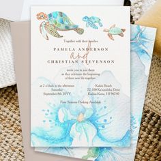 a wedding card with watercolor flowers and sea turtles on the front, in blue