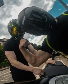 a man in black shirt and helmet riding a motorcycle