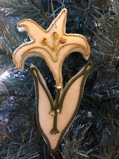 an ornament hanging from a christmas tree in the shape of a starfish