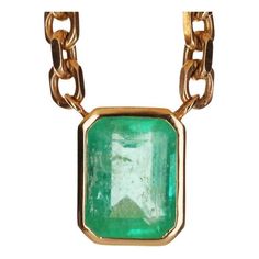 A spectacular unisex emerald solitaire necklace. The featured stone is 7.61-carats, emerald cut. The emerald has a beautiful medium green color, with very good luster and minor imperfections. This large beauty is set in a bezel-set, 14K yellow gold setting. The chain is solid gold and is 22.5 inches total with two stoppers so the necklace can be worn at shorter lengths. Setting Style: Bezel - Solitaire Setting Material: 14K Yellow Gold Weight: 61 Grams Main Stone: Colombian Emerald Shape: Emeral Luxury Emerald Necklaces With Bezel Setting, Rectangular Emerald Jewelry With Bezel Setting, Formal Emerald Necklace With Square Pendant, Classic Green Emerald Necklace With Bezel Setting, Yellow Gold Emerald Jewelry With Rectangular Stone, Luxury Green Emerald Cut Necklace, Rectangular Emerald Necklace For May Birthstone, Formal Emerald Cut Emerald Necklace For May Birthstone, Formal Emerald Rectangular Pendant Necklace