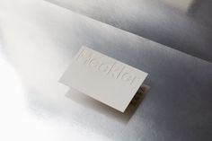 a white piece of paper with the word hackler on it sitting on top of a shiny surface