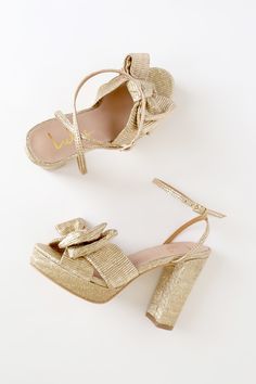 The Lulus Lilsa Gold Metallic Bow Platform Ankle Strap Heels are here to bring a perfect party look! Crinkle textured metallic fabric shapes these glam heels that have an open toe and crisscrossing straps that tie together at a large bow. A matching strap wraps around and secures above the ankle with a silver buckle. Trendy 0.75"" toe platform. Block heel. 4. 25" wrapped block heel. Cushioned insole. Felted rubber sole has nonskid markings. Man made materials. Imported. Lulus | Lilsa Gold Metall Chic Holiday Heels With Wrapped Heel, Gold Heels With Heel Strap For Party Season, Open Toe Heels For Gala And Party Season, Gold Sandals With Heel Strap For Party Season, Chic Holiday Heels With Open Toe, Gold Heels For Summer Events, Gold Open Heel Heels For Party Season, Chic Holiday Open Toe Heels, Gold Block Heel Party Heels