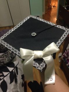 a black and white graduation cap with a bow