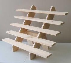 a wooden shelf sitting on top of a white table