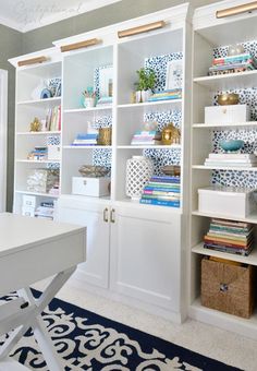 a white bookcase filled with lots of books