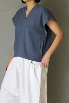 SASAKI-CHIHO(Antique fabric) "Antique linen short sleeves V-neck blouse"  Handmade by Chiho Sasaki Material:Antique linens, from France. Color: Over-dyed,Blue-gray. Size: Neck to cuff : 9.8 inch (25 cm) Chest measurement :41.7 inch(106 cm) Shoulder to hem: 21.2 inch (54 cm) Model:5'2"(157 cm) Thank you Blue Linen V-neck Blouse, Indigo Linen Summer Tops, Summer Linen Tops In Indigo, Summer Indigo Linen Tops, Linen Tops With Natural Dye And Short Sleeves, Short Sleeve Linen Tops With Natural Dye, Gray Blouse, Antique Fabrics, Blouse Sleeveless