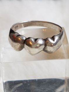 This Rare and Vintage Romantic Signed NF 925 Ring features triple hearts design and is being listed just in time for Valentine's Day. This ring is in a size 7 and is in great vintage condition. The ring will arrive in a ring box with FREE SHIPPING. Please let me know upon purchasing if you would like me to polish it for you. Adjustable Vintage Heart Ring, Vintage Silver Rings For Valentine's Day, Vintage Silver Heart Ring For Valentine's Day, Vintage Heart Ring For Valentine's Day Promise, Vintage Silver Heart Ring For Anniversary, Vintage Sterling Silver Heart Ring For Valentine's Day, Vintage Adjustable Heart Ring For Anniversary, Vintage 925 Stamped Heart Ring For Anniversary, Vintage Sterling Silver Heart Cut Ring