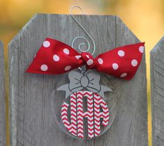 a wooden fence with a red and white polka dot bow hanging from it's side