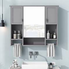 a bathroom sink sitting under a mirror next to a white counter top with two towels hanging on it