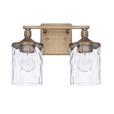 two light bathroom fixture in an antique brass finish with clear glass shades and metal fittings