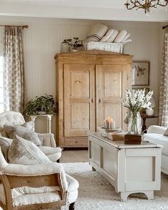 a living room filled with furniture and a chandelier