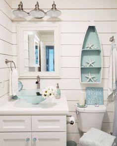 a bathroom with white walls and blue accents