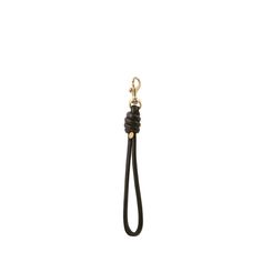 a black leather keychain hanging from a hook