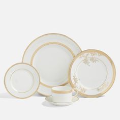 a white and gold dinnerware set