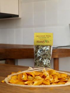 a bag of orange peel chips sitting on top of a wooden table