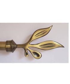 a brass colored door handle with two leaves on it's end and one leaf attached to the top