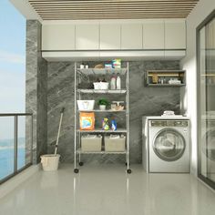 a washer and dryer in a room next to a window with an ocean view