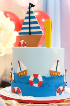 a blue and white cake with a boat on top